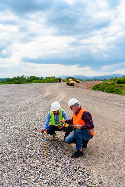 istock Two engineers check the PIN against the road plan 2252220288