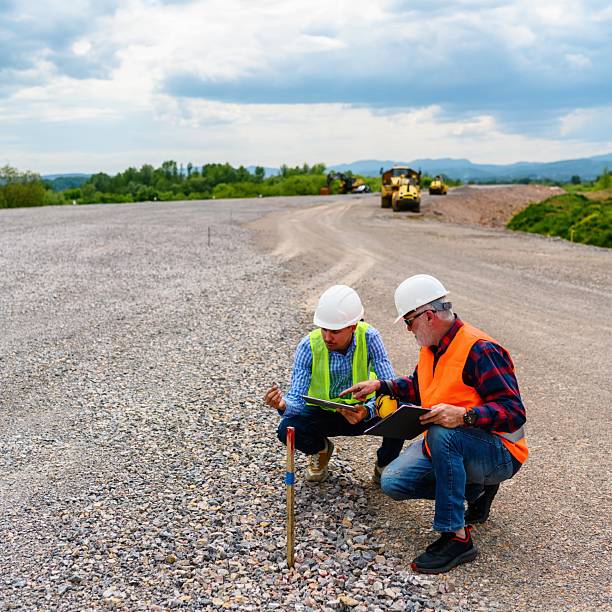 istock Two engineers check the PIN against the road plan 2252220694