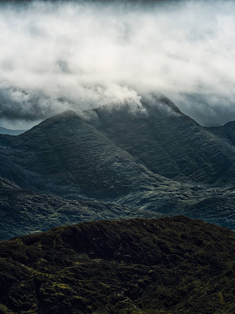 istock Striking vertical composition showcasing rugged mountains, where muted tones and cloudy skies create a sense of depth and ethereal beauty. Majestic nature! 2252220904