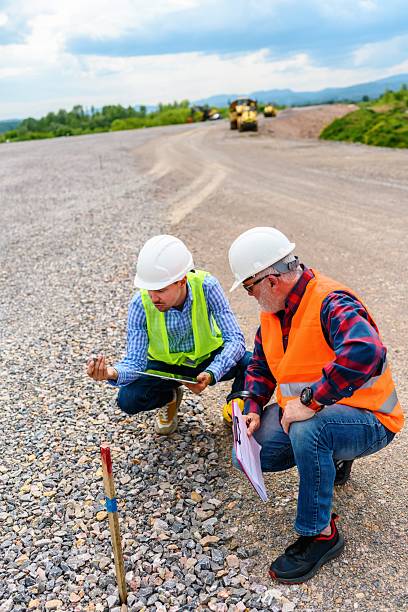 istock Two engineers check the PIN against the road plan 2252221700