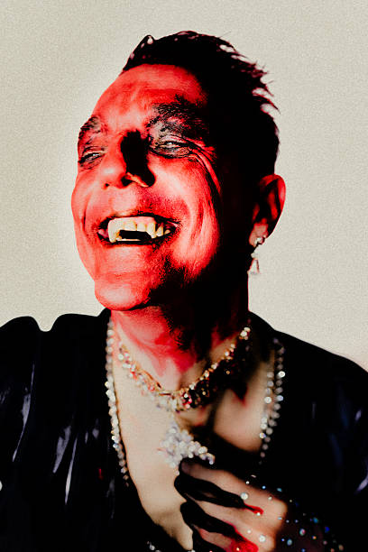 An expressive portrait of a drag queen in dramatic lighting and intense colours. The open smile, extreme make-up and opulent jewellery elements refer to transformation, self-empowerment and queer visibility. The image celebrates drag as an artistic practice and statement for freedom, physicality and lived identity.