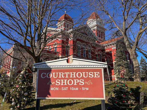 Sign for The Courthouse Shops at the Crown Point Courthouse on a winter day surrounded by Christmas decor. Crown Point, IN USA November 28, 2025