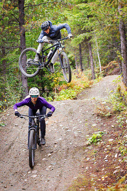 Man riding electric bike fast on mountain road, blurred motion view