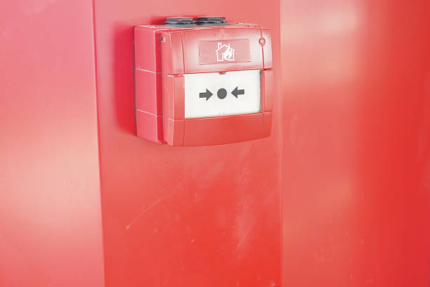 istock Fire alarm box mounted on a bright red wall indoors 2252230154