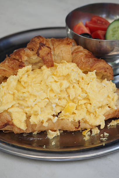 istock Scrambled eggs served in a flaky croissant at brunch 2252233071