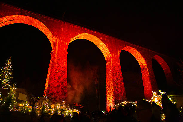 istock Illuminated historic brick viaduct with Christmas lights at night 2252233210