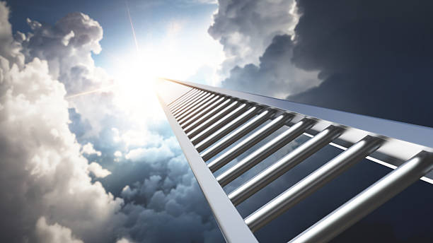 istock Camera moves along a ladder reaching into bright clouds on a sunny day in a clear blue sky 2252236423