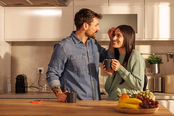 istock Couple drinking morning coffee in kitchen at home 2252236971