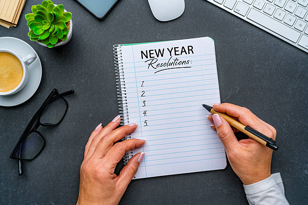 istock Person and checklist in black workspace desk with New Year resolution notebook. Goals, resolutions, plan, target, action, checklist for the coming year 2252238350