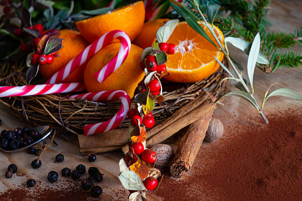 Cinnamon sticks, hibiscus, and star anise arranged on a wooden board in the kitchen, perfect for winter tea