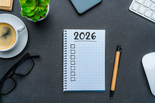 istock Overhead view of workspace desk with 2026 New Year resolution list notebook. Goals, resolutions, target, plan, action, checklist for the coming year. 2252238830