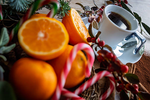 yellow tangerines on the table against the background of the Christmas tree