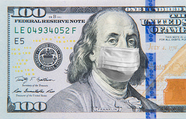 istock Benjamin Franklin in a mask on a 100 dollar bill isolated on white background. Concept of prevention of money from crisis. 2252239619