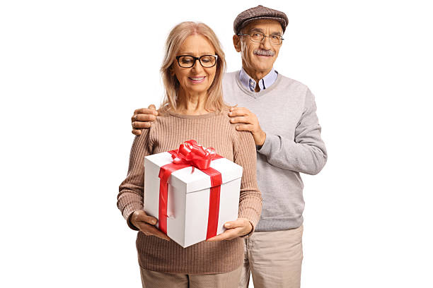 istock Mature couple with a gift box standing together 2252245761