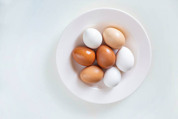 Three Brown Chicken Eggs Arranged On Clean White Background With Shallow Depth Of Field, Representing Natural Food, Organic Nutrition, Minimalist Still Life, And Simple Studio Composition.