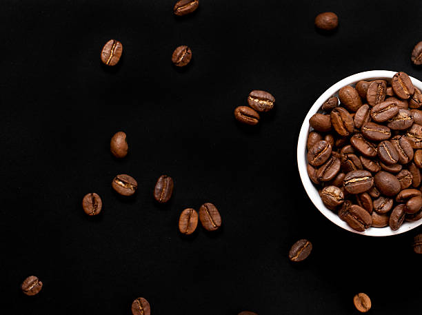 istock Dark background with coffee beans on it. Cup with coffee 2252251057