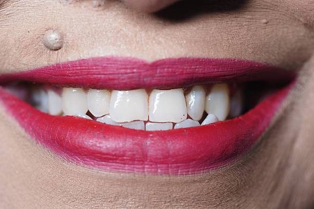 Smile, close up shot of a beautiful female mouth and lovely shiny white teeth smiling happily.