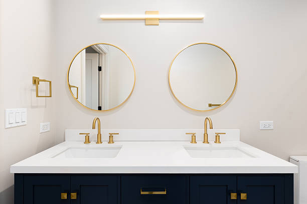 istock A bathroom with a blue cabinet and gold accents. 2252259407