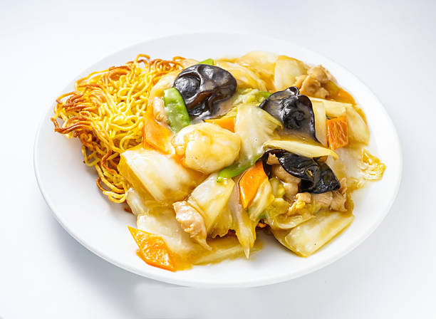 Delicious stir fry noodles with shrimp and vegetables on a plate