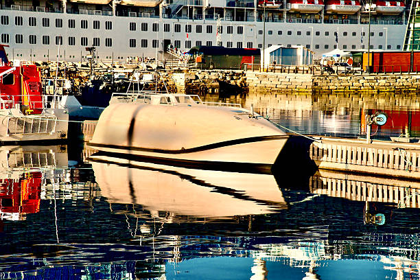 Marseille, France March 15, 2025 Boats docked at night in Le Vieux Port under the Ombriere structure built by architect Norman Foster.