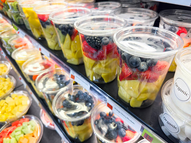 Colorful Fresh Fruit Bowls and Salad Cups on Refrigerated Supermarket Display Shelf