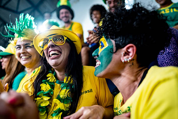 istock Excited brazilian fans cheering with enthusiasm while watching soccer match 2252264183