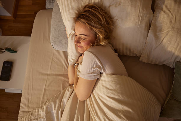 istock Woman peacefully sleeping in bed getting rest. 2252266128