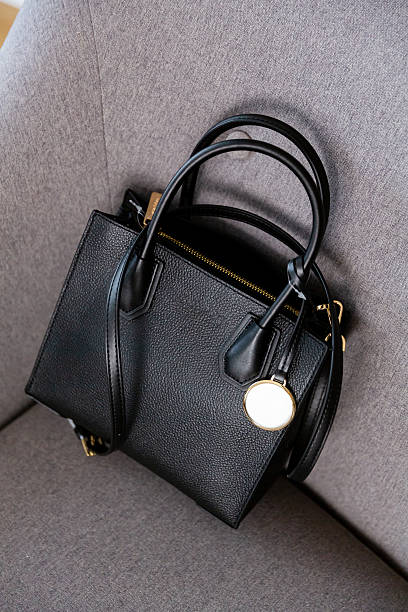 istock Black leather crossbody bag, minimalist design on a light environment 2252266370