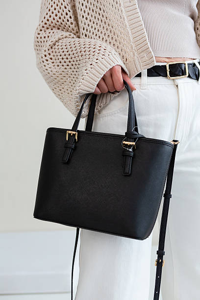istock Black leather crossbody bag, minimalist design on a light environment 2252266380