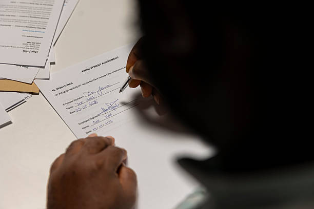 istock Close up of a man signing work contract with human resources manager 2252267448