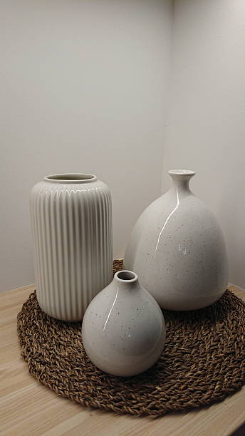istock Minimalist ceramic vases arranged on natural woven mat 2252268626