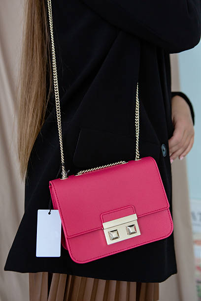 istock A young woman has a bright pink small handbag. 2252268655