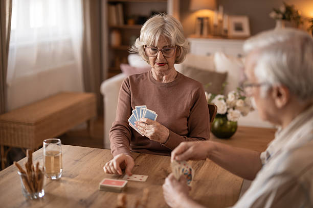 istock Two Seniors Enjoying A Card Game At A Cozy Home Table 2252269118