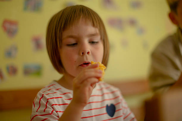 istock Casual afternoon bonding through shared pastry and playful interactions 2252272179