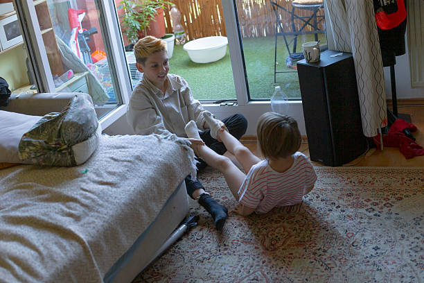 istock Young boy and sister perform stretching on sunny balcony floor 2252275233