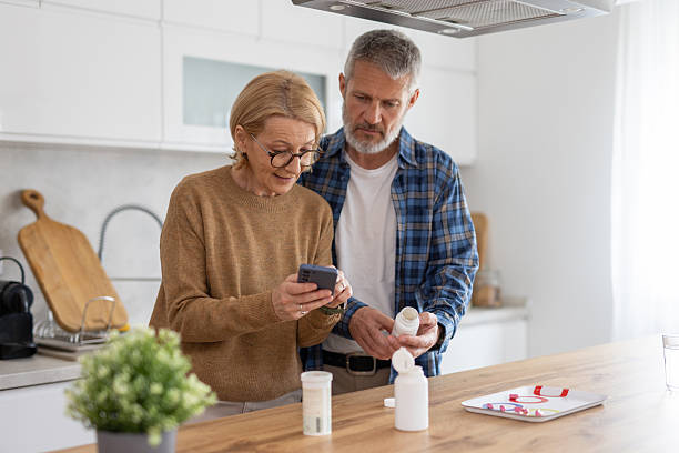 istock Seniors Engaging with Medication Bottles in Bright Kitchen 2252276336