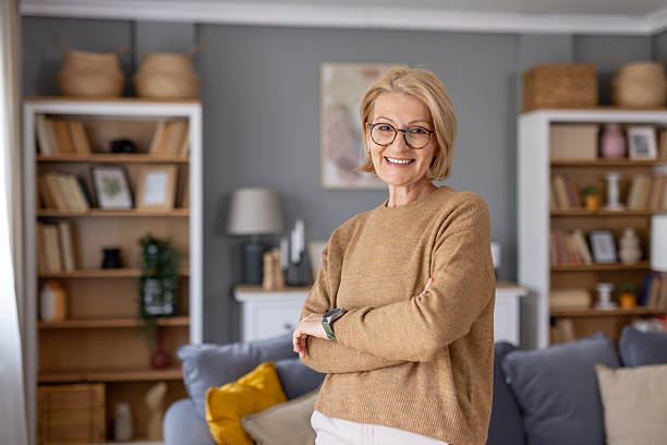 istock Older woman radiating joy in a modern living space 2252276344