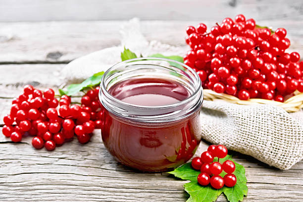 istock Jam viburnum in jar on wooden board 2252276385
