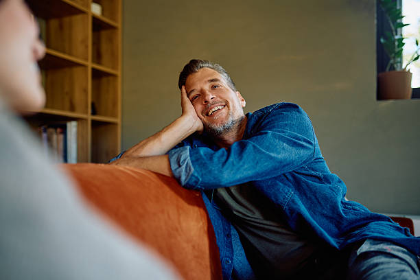 istock Man relaxing on couch listening intently to conversation 2252277148