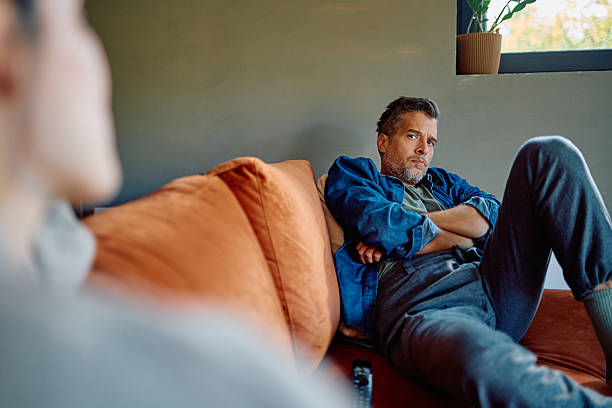 istock Frustrated man sitting on sofa ignoring partner during conflict 2252277242