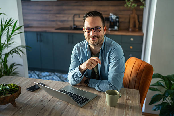istock Man working from home with laptop on wooden table 2252278409
