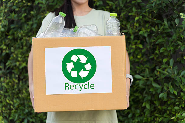 istock Woman Holding Recycling Box with Plastic Bottles Eco Friendly Environmental Concept 2252278531