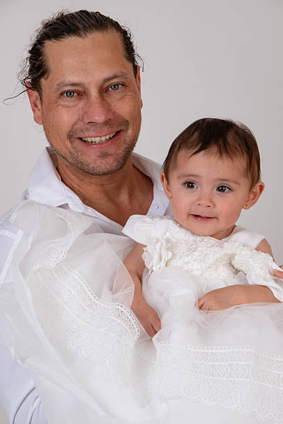 father posing with his baby during a photo shoot