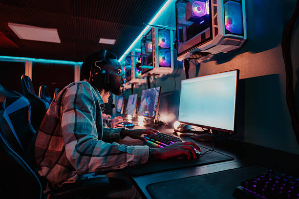 istock Male gamer playing video game in internet cafe 2252279516