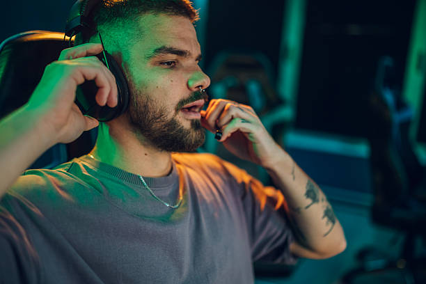 istock Male gamer wearing headset talking during online streaming 2252279615