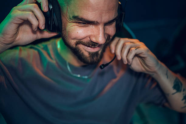 istock Male gamer smiling wearing headset with microphone 2252279620