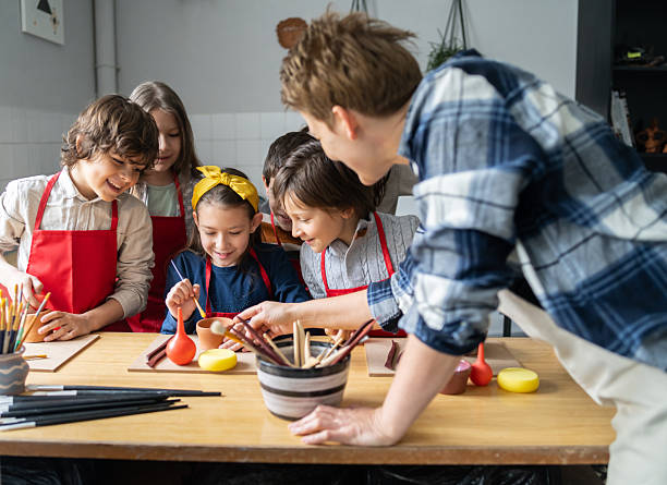 istock Children creating a clay sculpture's 2252280328