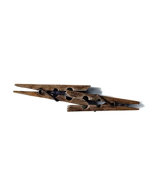 A close up, shot of purple clothes pegs standing on a white background. The focus is on one of the pegs is lying flat.