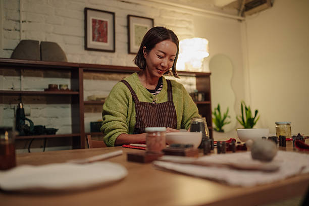 istock Asian woman crafting pottery in ceramic workshop 2252283876