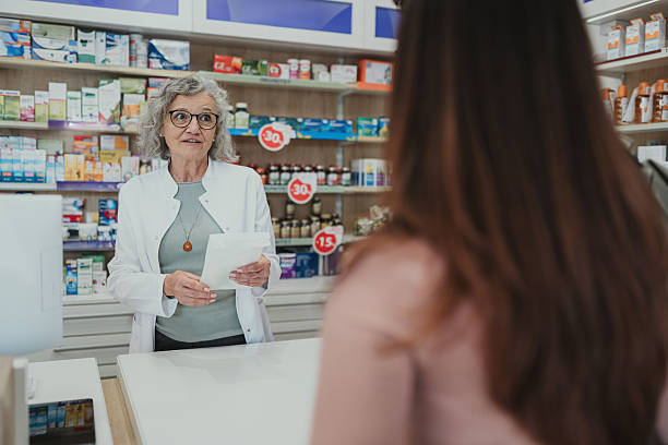istock Pharmacist advising customer about prescription medication at pharmacy counter 2252284826